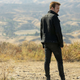 Caleb (Aaron Paul), a man in black.